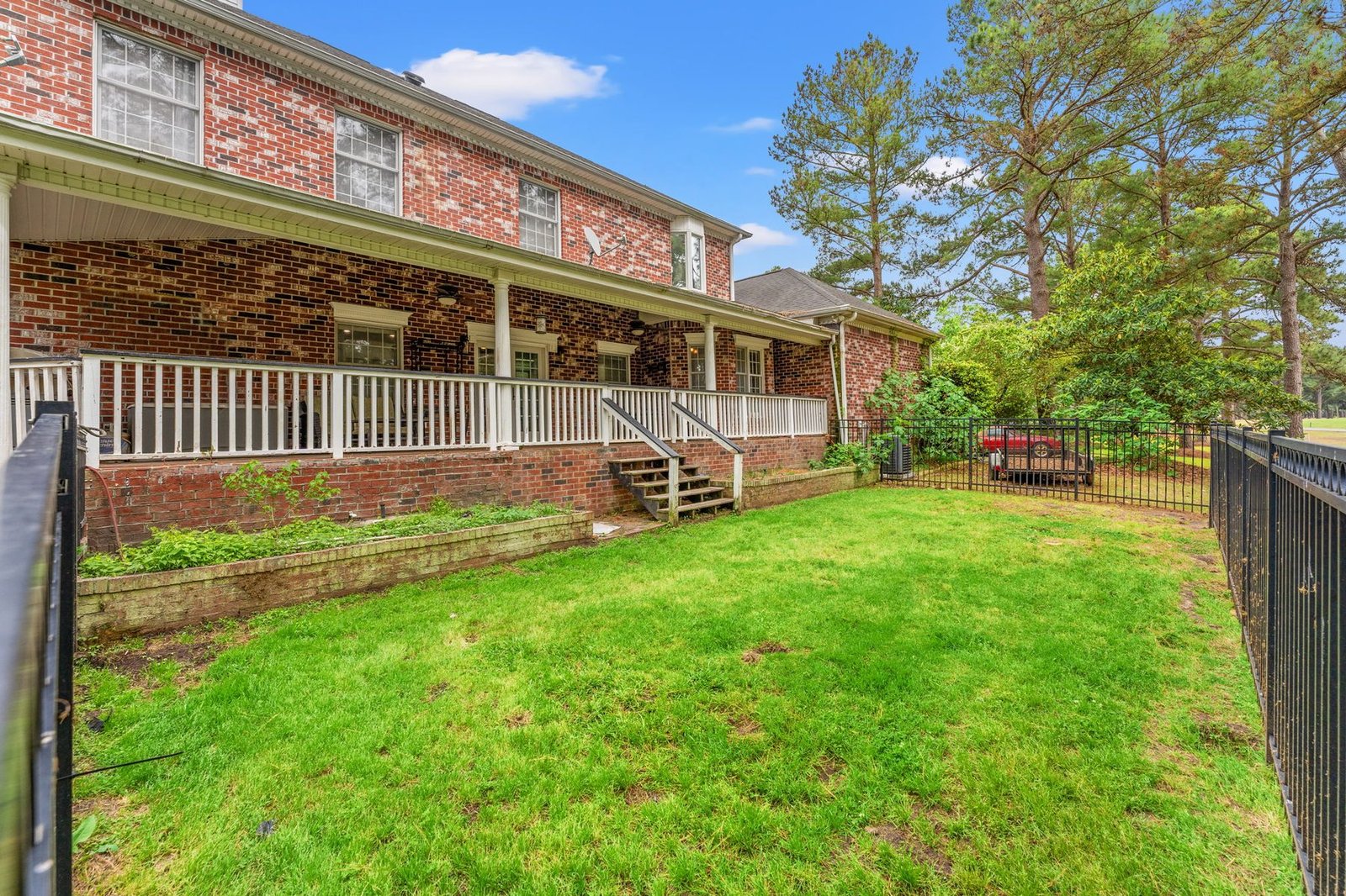 Fenced backyard with golf course setting